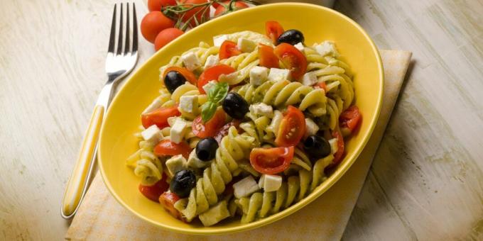 Salad with pasta, tomato, olives, mozzarella and mustard dressing