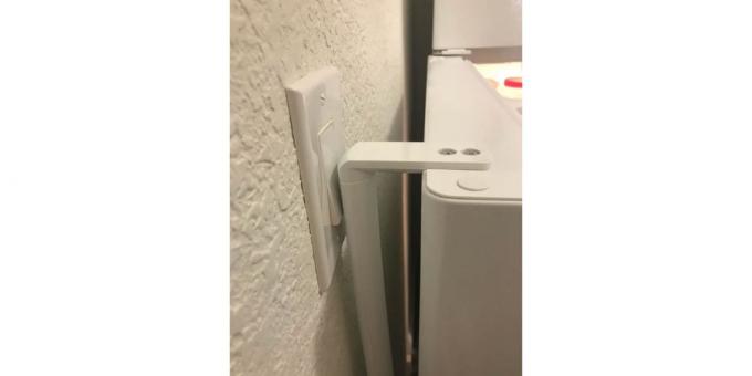 a refrigerator and a switch in the kitchen