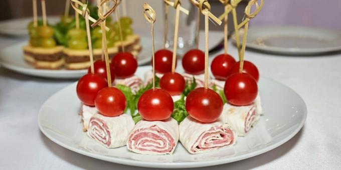 Canape rolls with sausage and cherry tomatoes