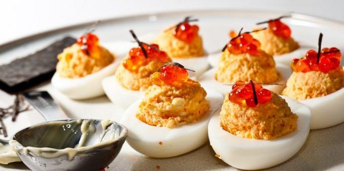 Stuffed eggs with red fish and caviar