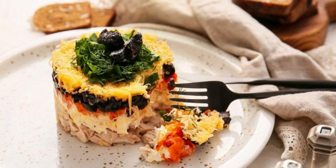 Layered salad with chicken, cheese and prunes