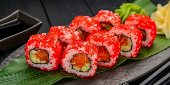 Rolls with red fish, cucumber and avocado