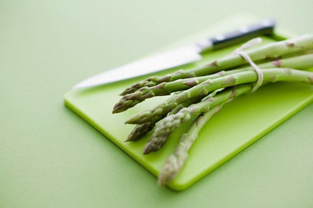 Asparagus on a green plastic board