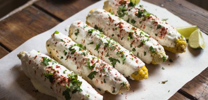 Mexican baked corn with sauce and herbs