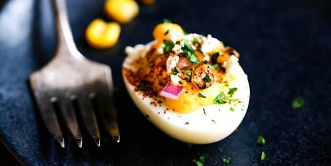 Stuffed eggs with corn and spicy sauce