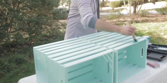 a coffee table with his hands: grind and color boxes