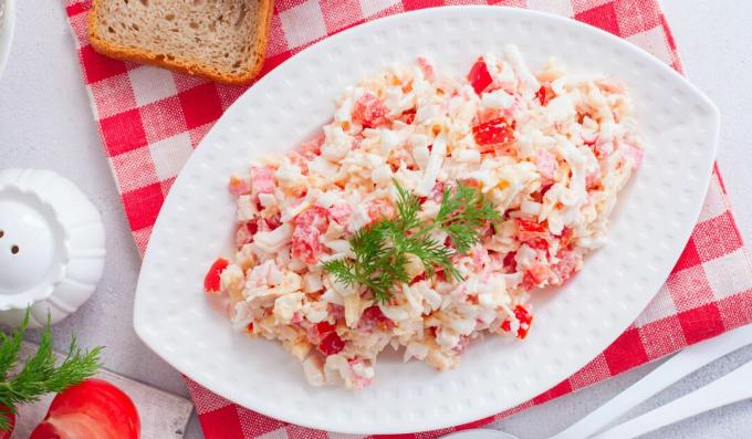 Salad with crab sticks, cheese and tomatoes