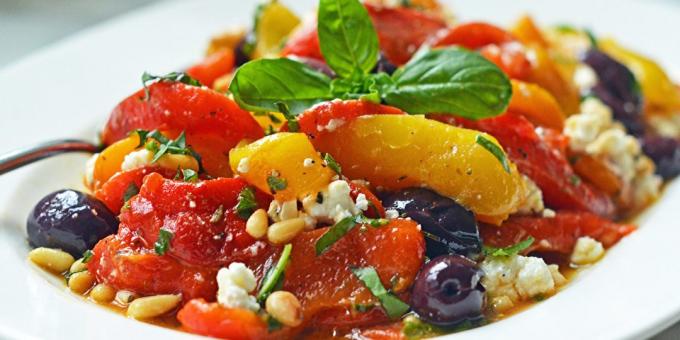 Salad with baked pepper, feta cheese, olives and pine nuts