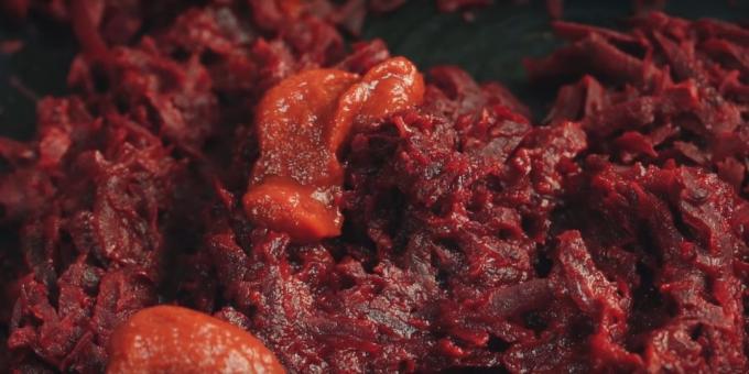 Step by step recipe for borscht: add the tomato paste, stir and leave on heat for another 5-7 minutes