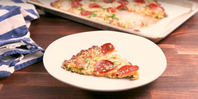 Zucchini Pizza with tomato sauce, cheese and sausage in the oven