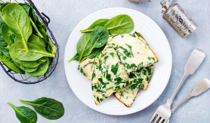 Omelet with spinach and cheese in a pan