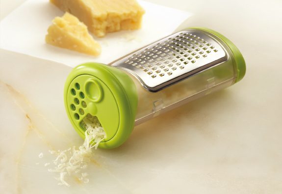 Grater for cheese with dispenser