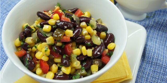 Salad with corn, beans, peppers, cucumbers and nuts
