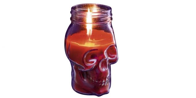 Candle in the form of a skull with a candlestick