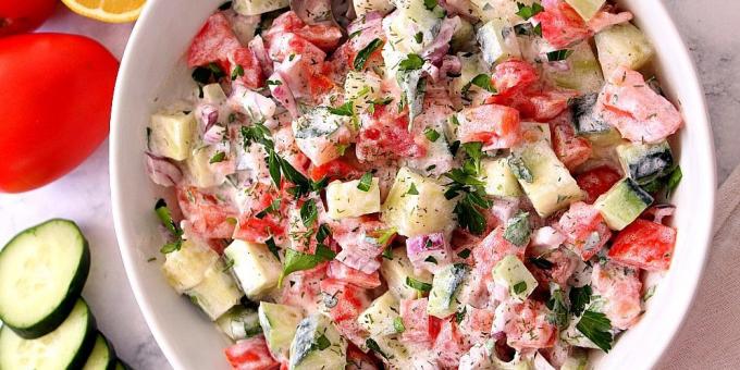 Salad with cucumbers and tomatoes with onions and sour cream dressing