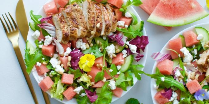 Salad with watermelon, feta, chicken, nuts and honey dressing