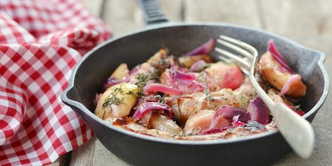 Stewed cabbage with apples and sausages in one bowl