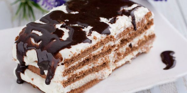 Cake pastry with whipped cream and chocolate icing