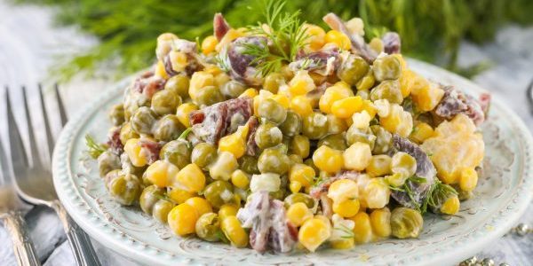 Salad with canned peas, corn and sausage