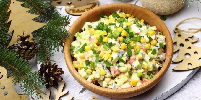 Salad with crab sticks, pickled and fresh cucumbers, corn and eggs