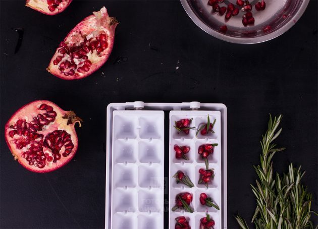 Champagne Rosemary Pomegranate Cocktail: Arrange the rosemary leaves and pomegranate seeds in ice cube trays