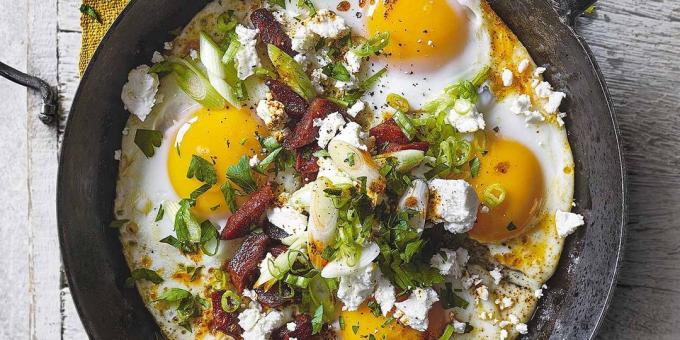 Fried eggs c sausage, feta cheese and herbs