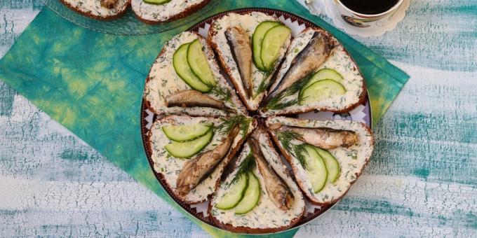 Sandwiches with sprats and melted cheese