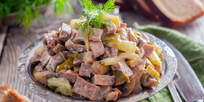 Salad with tongue, cucumbers and mushrooms