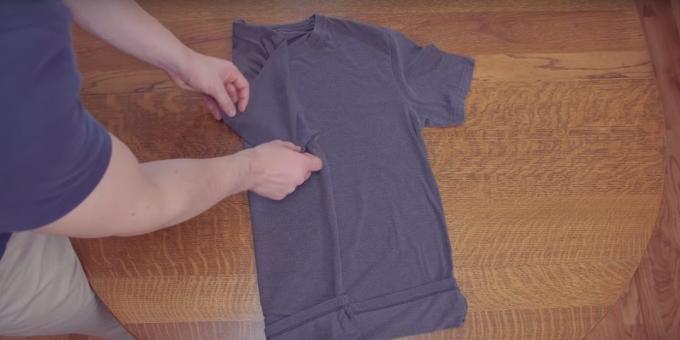 Fold the middle of one of the shirts and fold the sleeve