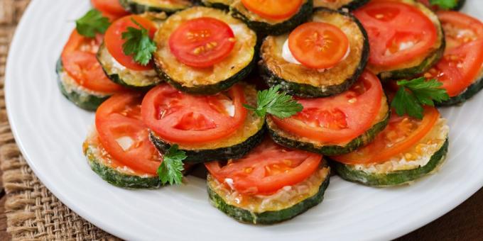 Fried zucchini with mayonnaise, cheese and tomatoes