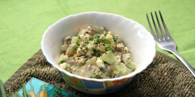 Salad with canned saury, eggs and cucumbers