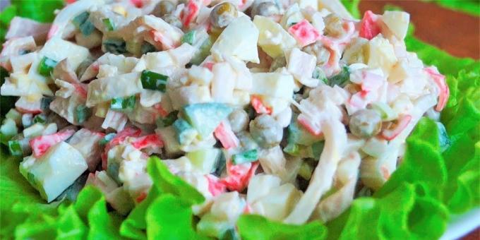 Salad with crab sticks, calamari, green peas, eggs and cucumbers