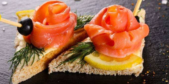 Sandwiches with red fish, butter and lemon