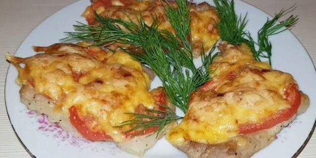 Chops with cheese and tomatoes in the oven