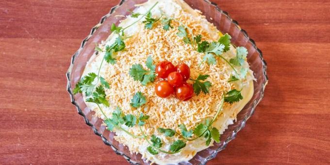 Layered salad with saury, cucumbers and peas