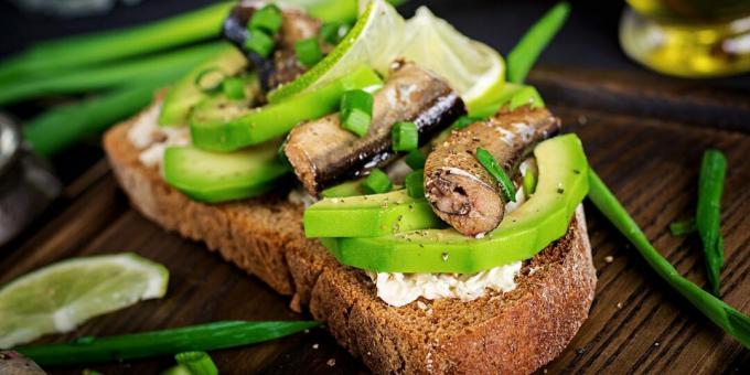 Sandwiches with sprats, avocado and curd cheese