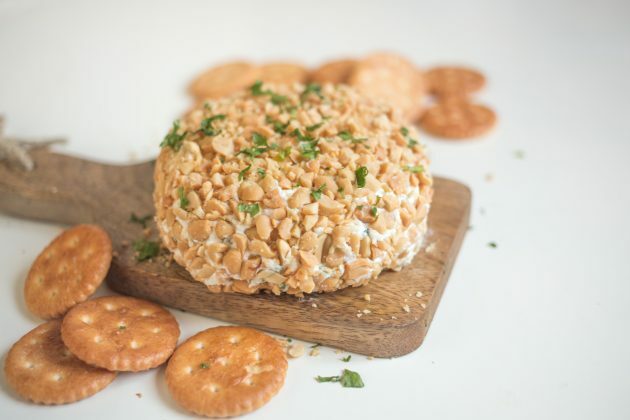 Dip a cheese ball in peanuts and serve a snack