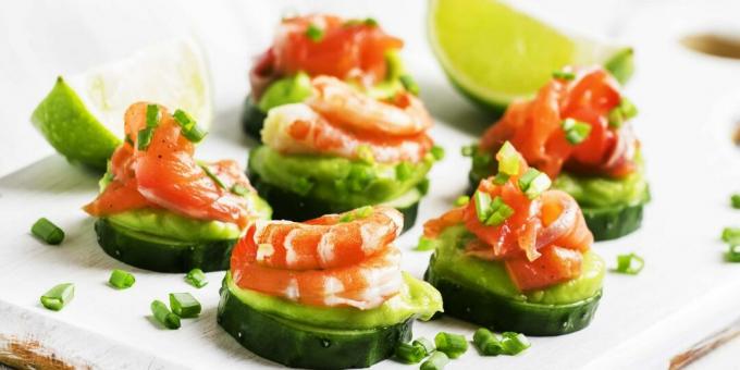 Cucumber canape with avocado sauce, fish and shrimp