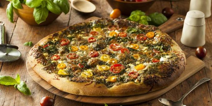 Pizza with cheese, tomatoes and pesto