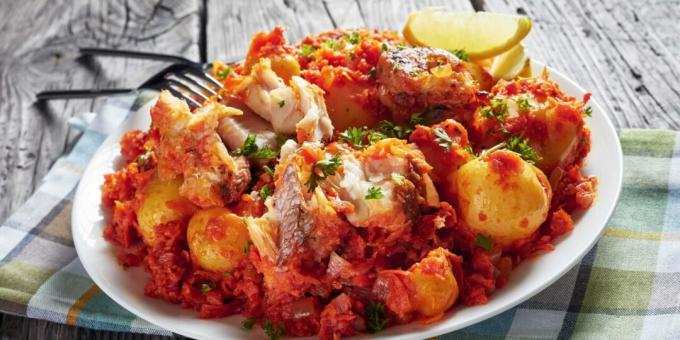 Hake with potatoes and tomato sauce in the oven
