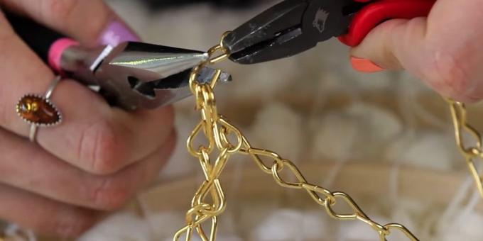 Pliers, open link in a long chain of extreme