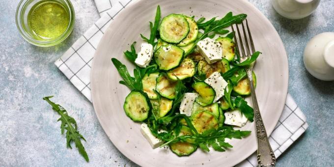 Salad with pickled zucchini, rocket salad, feta and lemon dressing