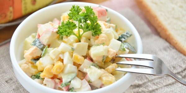 Salad with crab sticks, corn and eggs