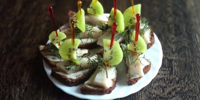 Canapes with herring recipes, cream cheese and kiwi