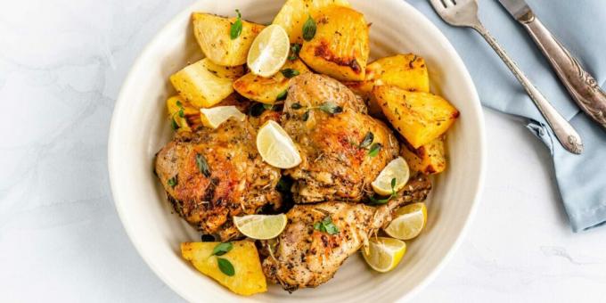 Chicken thighs with potatoes and lemon in the oven