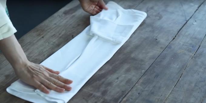 Fold the middle of the right side of the shirts and fold the sleeve