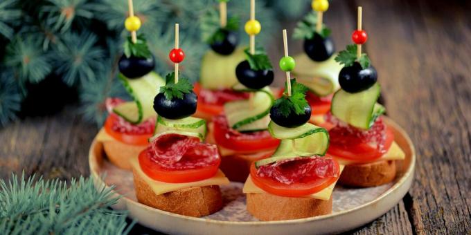Canapes with sausage, olives and cheese
