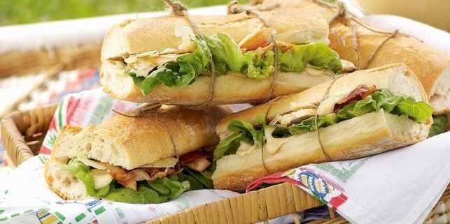 Caesar salad with chicken and prosciutto in a sandwich