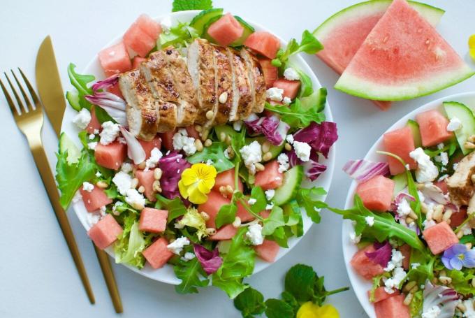 Salad with watermelon, feta, chicken, nuts and honey dressing