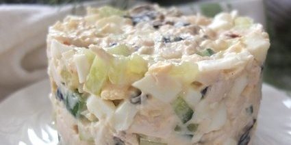 Salad with prunes, chicken, eggs and cucumber